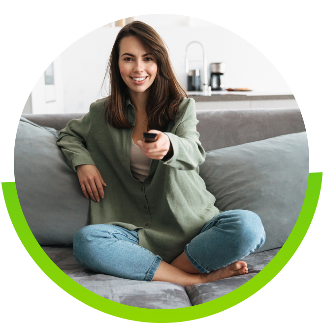 Woman sitting on the couch with remote